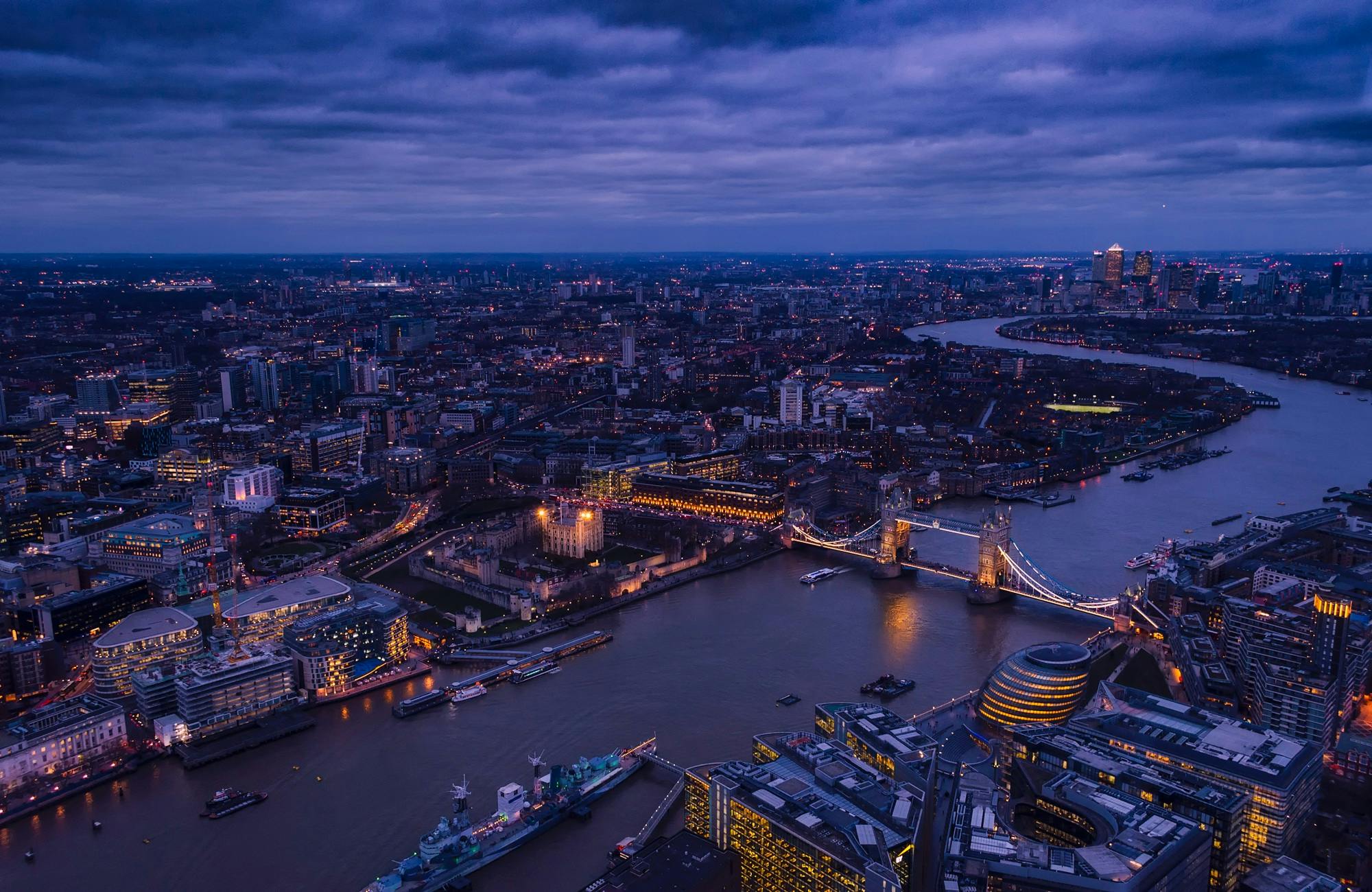 Aerial night view of London with Tower Bridge and Thames River.