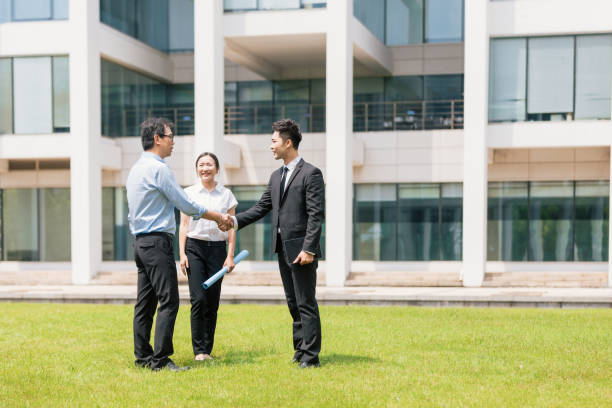Overseas landlords meeting London letting agent outside apartment building