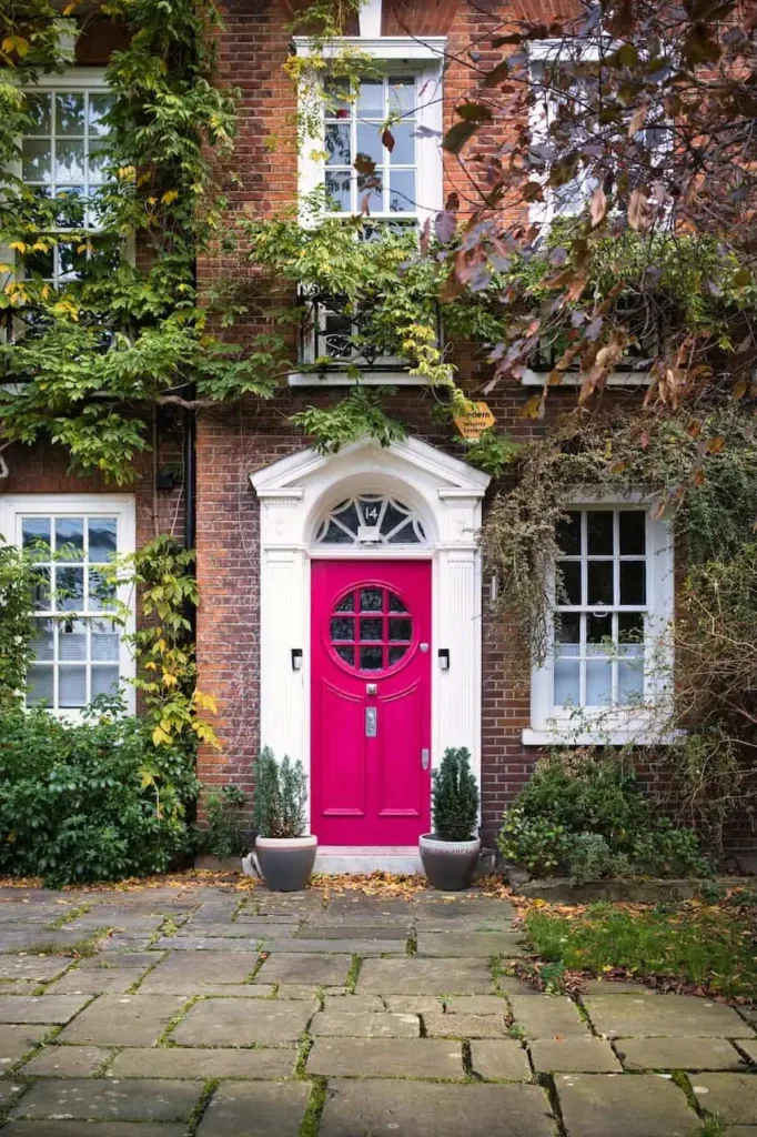 genuine West London period townhouse or mews house, ideally with attractive planting or climbing greenery. Premium professional property photography in natural daylight.
